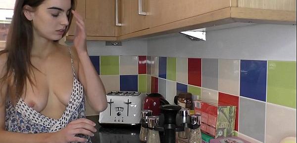  Sexy busty brunette smelling the spices in the kitchen